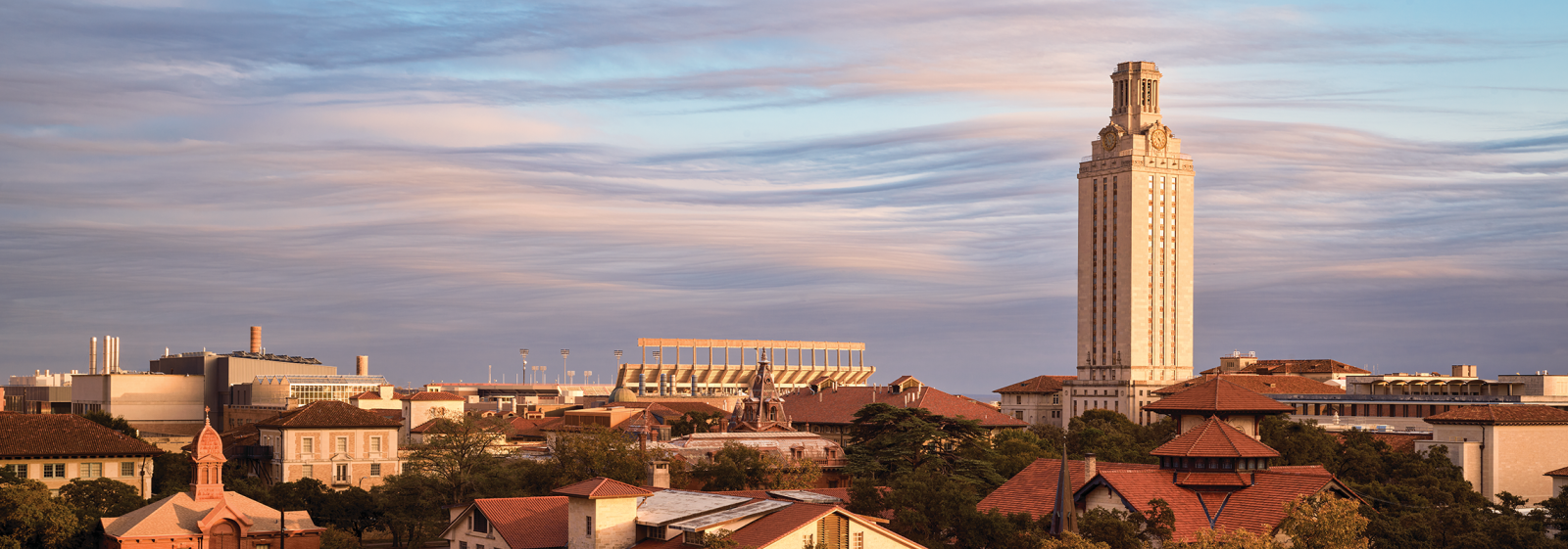The UT Tower with purple and blue clouds behind it.
